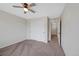 Inviting bedroom featuring soft carpet, ceiling fan, and access to other rooms, offering comfort and convenience at 23539 E Ida Dr # C, Aurora, CO 80016