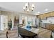 Inviting dining area features stylish chandelier, wood floors, and is adjacent to the kitchen and living areas at 23539 E Ida Dr # C, Aurora, CO 80016