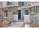This is an exterior view of the townhome featuring stone and gray wood accents at 23539 E Ida Dr # C, Aurora, CO 80016