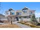 Charming townhome exterior with stone accents, gray siding, and a well-manicured lawn and garden at 23539 E Ida Dr # C, Aurora, CO 80016