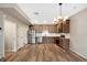 Modern kitchen featuring stainless steel appliances, hardwood flooring, and a stylish chandelier at 23539 E Ida Dr # C, Aurora, CO 80016