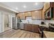 Modern kitchen boasts stainless steel appliances, granite countertops, and wood floors at 23539 E Ida Dr # C, Aurora, CO 80016