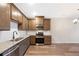 Well-equipped kitchen with stainless steel appliances, granite countertops, and wood plank flooring at 23539 E Ida Dr # C, Aurora, CO 80016