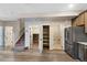 Open kitchen area with stainless steel appliances, wooden cabinets, and convenient pantry access at 23539 E Ida Dr # C, Aurora, CO 80016