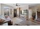 Welcoming living room features wood-look flooring, a fan, and a decorative brick accent wall, perfect for relaxation at 23539 E Ida Dr # C, Aurora, CO 80016