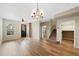 Inviting living area featuring hardwood flooring, a modern chandelier, and easy access to the kitchen at 23539 E Ida Dr # C, Aurora, CO 80016