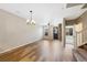 Open-concept living space featuring a brick accent wall, hardwood flooring, and ample natural light at 23539 E Ida Dr # C, Aurora, CO 80016