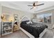 Main bedroom featuring a tray ceiling, large window, and carpeted floors at 23539 E Ida Dr # C, Aurora, CO 80016