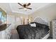 Spacious main bedroom with ceiling fan, trey ceiling, and adjacent bathroom at 23539 E Ida Dr # C, Aurora, CO 80016