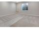 Bright basement with new carpet, base trim, a large window, and neutral colored walls at 24811 E 33Rd Dr, Aurora, CO 80019