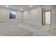 Open basement area with neutral walls, new carpet, and a bright window at 24811 E 33Rd Dr, Aurora, CO 80019