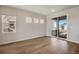 Bright living room with hardwood floors and sliding door access to patio at 24811 E 33Rd Dr, Aurora, CO 80019