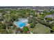 Overhead view of a neighborhood pool surrounded by trees, amenities, and lush landscaping at 2737 Ulster St, Denver, CO 80238