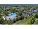 Wide aerial shot featuring a pool, green space, and a cluster of neighborhood homes in a scenic setting at 2737 Ulster St, Denver, CO 80238