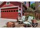 Private backyard area with a fire pit, chairs, and a two-car detached garage at 2737 Ulster St, Denver, CO 80238
