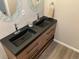 Elegant bathroom vanity with double sinks, stylish faucets, and dark countertops at 2737 Ulster St, Denver, CO 80238