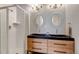 Modern bathroom featuring a sleek double vanity, stylish mirrors, and a glass-enclosed shower at 2737 Ulster St, Denver, CO 80238