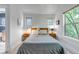 This bedroom features carpet flooring and two large windows that bring in tons of natural light at 2737 Ulster St, Denver, CO 80238
