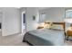 This bedroom features carpet flooring, a window, and an ensuite bathroom at 2737 Ulster St, Denver, CO 80238