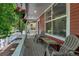 Relax on the cozy front porch with hanging flowers and comfortable seating at 2737 Ulster St, Denver, CO 80238