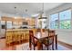 Well-lit kitchen and dining area features stainless appliances and a granite island at 2737 Ulster St, Denver, CO 80238