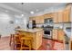 Spacious kitchen features stainless steel appliances, granite countertops, wood cabinets, and a large island at 2737 Ulster St, Denver, CO 80238