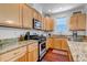 This kitchen features stainless steel appliances, granite counters, and wood cabinets at 2737 Ulster St, Denver, CO 80238