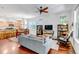 Bright and airy living room with hardwood floors, open to kitchen, and large windows at 2737 Ulster St, Denver, CO 80238