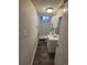 Cozy bathroom with a shower, toilet, sink, mirror, and cabinet at 5552 Abilene St, Denver, CO 80239