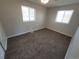 Bedroom featuring two windows, carpet, and neutral walls at 5552 Abilene St, Denver, CO 80239
