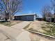Charming single-story home with a well-maintained yard and attached garage at 5552 Abilene St, Denver, CO 80239