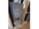 View of the Rheem brand gas furnace with yellow gas line connections and vent showing the unit's details at 5552 Abilene St, Denver, CO 80239