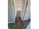 Hallway with wood flooring leading to a carpeted room at 5552 Abilene St, Denver, CO 80239