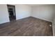 Spacious living room featuring wood-look flooring and natural light at 5552 Abilene St, Denver, CO 80239