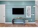 Close-up of stylish accent wall with mounted TV and modern decor, creating a cozy atmosphere at 1787 W 166Th Ave, Broomfield, CO 80023
