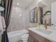 Chic bathroom with textured tile, modern vanity, and decorative accents at 1787 W 166Th Ave, Broomfield, CO 80023