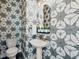 Chic powder room with geometric wallpaper, pedestal sink, and gold-tone fixtures at 1787 W 166Th Ave, Broomfield, CO 80023