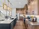 Spacious kitchen with stainless steel appliances, modern lighting, wood floors, and ample counter space at 1787 W 166Th Ave, Broomfield, CO 80023