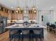 Well-appointed kitchen featuring an island with seating, modern appliances, and stylish lighting fixtures at 1787 W 166Th Ave, Broomfield, CO 80023