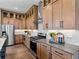 Well-equipped kitchen featuring stainless appliances, light wood cabinets, and modern backsplash at 1787 W 166Th Ave, Broomfield, CO 80023