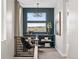 Well-lit office space with modern lighting, view from the window, dark blue accent wall, and built-in shelving at 1787 W 166Th Ave, Broomfield, CO 80023