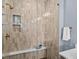 Modern shower featuring a built-in niche, bench, and decorative tile at 1787 W 166Th Ave, Broomfield, CO 80023