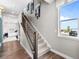 Bright stairway with carpeted steps and modern railings, illuminated by a window at 1787 W 166Th Ave, Broomfield, CO 80023