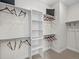 Well-organized walk-in closet with multiple shelves, hanging rods, and neutral carpeting at 1787 W 166Th Ave, Broomfield, CO 80023