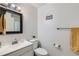 Clean, well-lit bathroom with a modern vanity, framed mirror, and decorative elements at 9943 Croke Dr, Denver, CO 80260