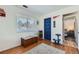 Bedroom with wood floor, window with blinds, closet and doorway to another room at 9943 Croke Dr, Denver, CO 80260