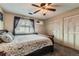 Comfortable bedroom with a ceiling fan, carpet, window and closet, offering a relaxing space at 9943 Croke Dr, Denver, CO 80260