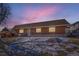 Charming brick home at dusk with cozy lighting in the windows at 9943 Croke Dr, Denver, CO 80260