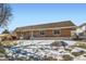 Brick exterior home featuring a well-maintained lawn and a tree-lined street at 9943 Croke Dr, Denver, CO 80260