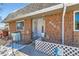 Charming front entrance with brick siding, decorative details, and a cozy welcome sign at 9943 Croke Dr, Denver, CO 80260